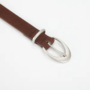 Women's brown matte suede leather belt with a minimalist silver oval buckle closure