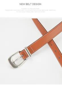 Detail of caramel brown leather belt with vintage metal buckle and white contrast stitching