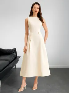 Detail view of cream sleeveless A-line dress with waist pockets and pleated skirt