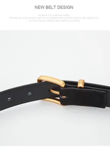 Close-up of vintage matte gold buckle on a slim black genuine leather belt for women