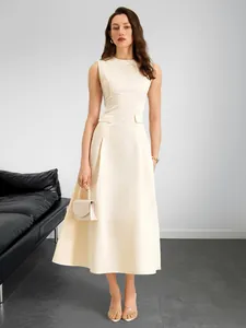 Detail of elegant beige A-line sleeveless dress featuring waist pocket flaps and pleats