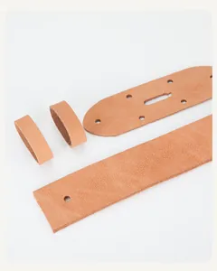 Detail view of brown cowhide leather strap components and pin buckle hole accessories