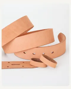 Detailed view of genuine vegetable tanned leather belt strap with pre-punched holes