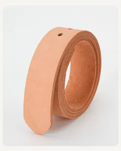 Macro detail of natural veg-tanned cowhide leather belt strap with pre-punched holes