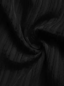 Macro shot of black textured fabric with vertical stripes and subtle jacquard patterns