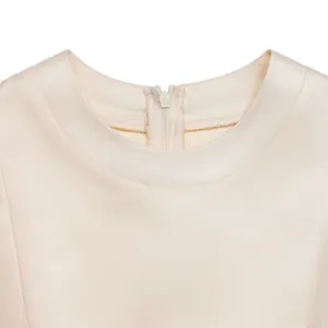 Detail of elegant beige satin dress neckline featuring a concealed back zipper