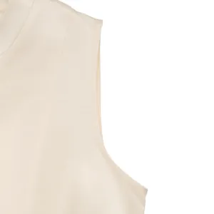 Detailed macro view of the cream satin sleeveless dress with premium stitching and edge finish