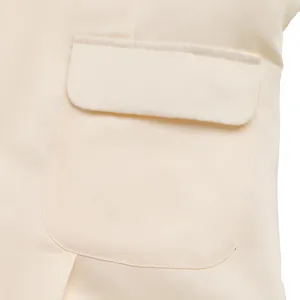 Detailed macro view of the cream white jacket pocket with a rounded flap and fine stitching