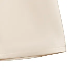 Detail of champagne satin dress showing high-quality stitching and smooth fabric texture