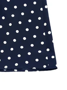 Detailed macro view of navy blue polka dot fabric texture and high-quality edge stitching