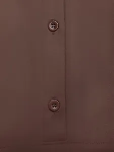 Détail de la patte de boutonnage en résine marron sur un body en maille extensible
