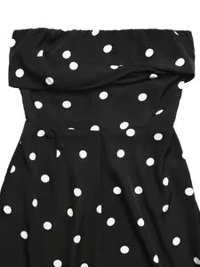 Detailed close-up of a black and white polka dot strapless jumpsuit with pleated neckline