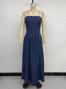 Detail of navy polka dot maxi dress featuring pleated bodice and thin spaghetti straps
