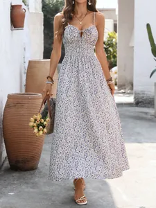 Detailed close-up of a floral maxi dress featuring a tie-knot neckline and smocked waist