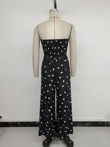 Rear view of polka dot strapless jumpsuit featuring elastic pleated waist and wide leg cut