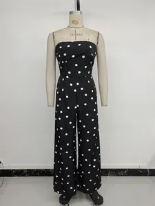 Close-up of strapless polka dot jumpsuit featuring crossover pleated chest detail