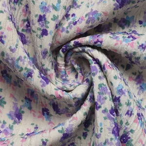 Close-up of lightweight floral fabric texture with lavender prints and ribbed patterns