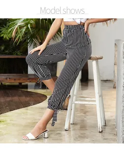 Detail of high waisted capri pants with black and white stripes and side tie leg cuffs