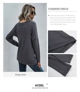 Detail of grey waffle knit fabric texture and stitching on a long sleeve V-neck top