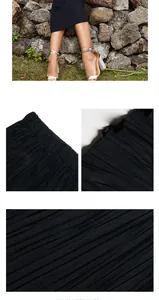 Detail of high waist elastic waistband and fine pleated texture on black summer skirt