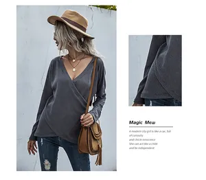 Detail view of dark grey waffle knit fabric with deep V-neck and crossover asymmetric hem