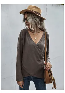 Detail of waffle knit texture on women's brown V-neck wrap top with irregular hemline