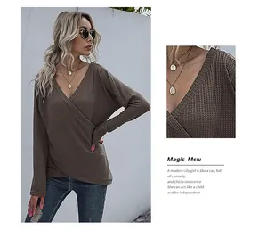 Detailed texture of brown waffle knit fabric on an asymmetrical V-neck wrap sweater