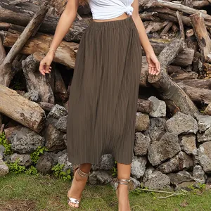 Brown high-waisted pleated midi skirt in lightweight fabric with a vertical drape finish