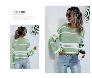 Detail of green and white striped knit sweater showing ribbed cuffs and soft fabric texture