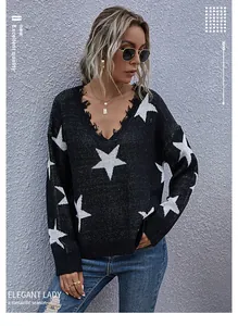 Close-up of distressed V-neckline and star jacquard knit texture on women's sweater