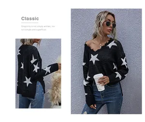 Close-up of distressed V-neckline and white star patterns on oversized black knit sweater