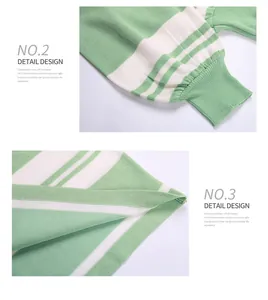Detailed close-up of ribbed cuffs and hem on a green and white striped knit sweater