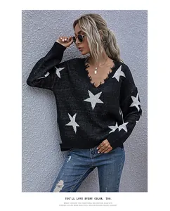 Detail of V-neck sweater showing distressed frayed edges and white star jacquard pattern