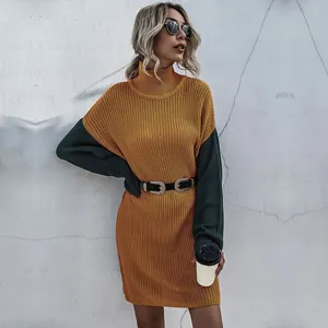 Detail of high-neck knit mini dress featuring mustard yellow and dark green contrast sleeves