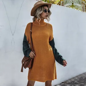 Detail of high neck color-block knit dress with ribbed texture and loose fit