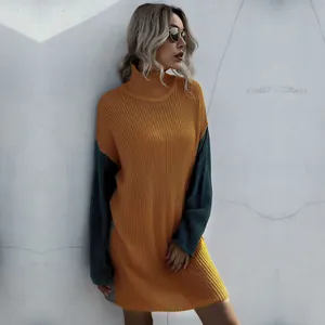 Detail of color-block knit dress featuring ginger body and dark green sleeves