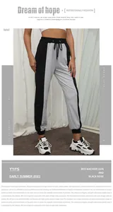 Detail of color-block joggers showing drawstring waist and tapered ankle cuffs in gray black