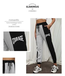 Detail of color-block joggers showing drawstring waist and white Courage letter print