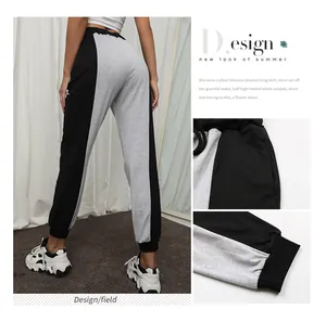 Detail view of women's two-tone jogger pants with elastic drawstring waist and side pockets