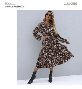 Detail of a leopard print long sleeve midi dress with a layered tiered skirt design