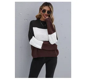 Detail of color-block knit sweater featuring textured waffle knit fabric and ribbed cuffs