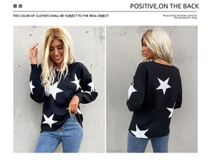 Detail view showing the large white star pattern on black knitted long sleeve sweater