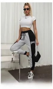 Detail of grey and black patchwork joggers with Courage letter print and drawstring waist