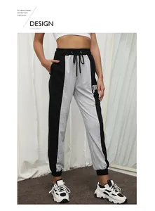 Detail of color-block sweatpants with drawstring waist and letter print on the leg