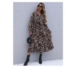 Detail of leopard print long sleeve dress featuring an elastic waist and tiered skirt