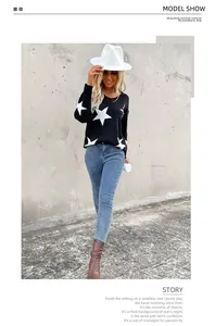 Detailed close-up of V-neck knitted sweater featuring bold white star pattern on black fabric