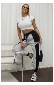 Detail of color-block joggers with white Courage letter print and drawstring waist