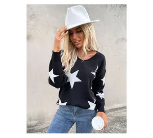 Close-up of black V-neck knit sweater with large white star patterns and textured fabric