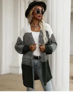 Detail of color-block knit cardigan showing white, grey, and dark green segments