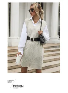 Close-up of cable knit vest with V-neck layered over a white shirt and pearl belt